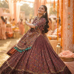 Anjali M. wearing a digital print muslin lehenga set, captured in a candid portrait with soft warm lighting.